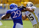 Yellow Jackets CB Michael Peterson works to pull down Kansas RB James Sims