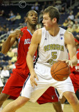 Yellow Jackets C Daniel Miller dribbles under the basket