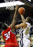 Jackets F Hosley fights off Hornets F Marques Oliver to put up a reverse layup