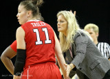 North Carolina State Head Coach Kellie Harper consults with her players during a stoppage of play