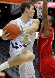 Yellow Jackets C Miller tries to pass from under the basket around Wolfpack G Brown
