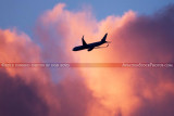 2012 - American Airlines B757-223 N183AN flying past colorful clouds over Miami lakes after sunset aviation stock photo