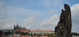 Sculpture on Charles Bridge and Prague Castle in the distance