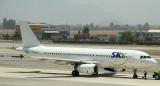 An A-320  belong to Sky Airlines in Chile in a hybrid livery