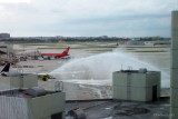 Miami-Dade County fire trucks performing a water cannon salute in honor of Dick Judy, longtime Dade County Aviation Director