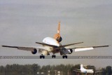 1979 - a VIASA DC10-30 landing on runway 30 as a Marco Island Airways Martin M-404 taxies in