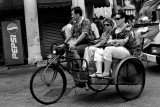 Sightseeing tourists taking a ride on a trishaw 