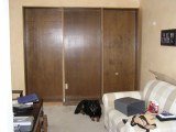 Three of the five bookcases that will fill the long wall in the front room.  Dog Bina is on the floor, posing.