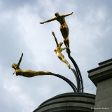 Three golden female nude divers