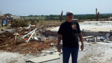 Homeowner Ron Mercer and in the background are the remains of his home where he pushed it from off the foundation