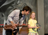 With his little sister, I believe