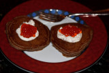 Salmon caviar on buckwheat blini