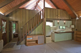 Cabin interior, kitchen right, bedroom left, loft above