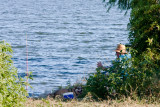 Just a man and his dog... waiting for the fish to bite. 