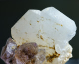 Milky quartz Japan-law twin, 2 cm, with amethyst. Ambatondrazaka, Toamasina Province, Madagascar.