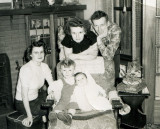 Grandma and Grandpa standing, baby Mom in the middle