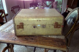 The suitcase. First view. Note the missing handles and rusted latches.