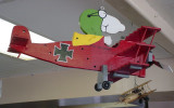 An airplane flying in the sky in the Hanger Caf. 