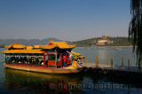 Dragon boat ferries on Kunming Lake with Buddhist temples on Longevity Hill of Summer Palace Beijing