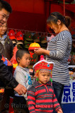 Chinese family shopping for hats for their two boys in Forbidden City Beijing China