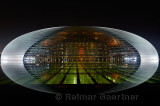 National Centre for the Performing Arts egg lit at night and reflected in water of pool Beijing China