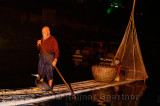 Chinese night fisherman calling to cormorant to catch fish in the Li river Yangshuo China