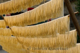 Noodles hanging outside in the sun to dry on rods in Fuli near Yangshuo China