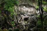 Wet belly of Laughing Buddha scultpure at Feilai Feng limestone grottoes at Ling Yin temple Hangzhou China