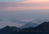 Pink glow at sunrise with fog in valley at North Sea area Huangshan Mountain China