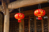 Red lanterns hanging on wood doorframe in ancient Chengkan village China