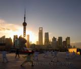 Tai Chi group exercising facing the sunrise and the Pudong high rise towers from The Bund Shanghai China