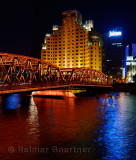 Shanghai Broadway Mansion Hotel and Outer Baidu Bridge over the Wusong river at night
