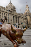 The Bund Financial Bull in Shanghai with Pudong Bank and Customs House clock tower China