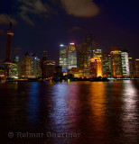 Twilight and Shanghai Pudong night lights reflected in the Huangpu river