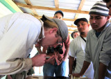 Ben assessing fat reserves of a bird.
