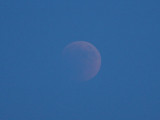 21:25 - More of the round moon becomes visible as the sky is getting darker