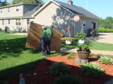 Placing boards on the ground so we dont ruin the grass.