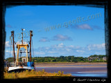 Trawler alongside the Lune estuary at low tide, Glasson Dock, Lancashire
