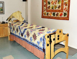 THE SEWING ROOM EVEN HAS AN  ELECTRONIC QUILTING MACHINE-NOTICE THE BEAUTIFUL QUILT ON THE WALL
