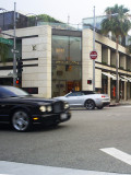 Bentley passing by Louis Vuitton on Rodeo Drive