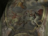the ceiling includes a sculpted leg and foot projecting from the arched painting