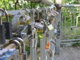 love locks on a pedestrian bridge high over a roadway in Misky Sad park