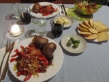 a kolbasa/onion/pepper fry-up with baked potato, olives, salad, and apple