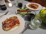 pizza, herring with cucumber & pickle, and salad