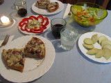 black olive & sausage pizza, herring with cream & peppers, salad, and apple