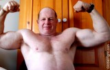 biceps older bear flexing.jpg