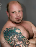 bald biker bear daddy huge biceps tattoos.jpg