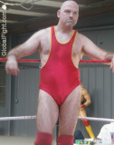 big stocky pro wrestler standing turnbuckle ringside.jpg