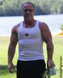 massively large biceps bulging muscles man in park.jpg
