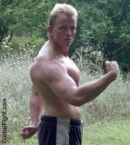blond muscleboy outside flexing biceps hunky guy.jpg